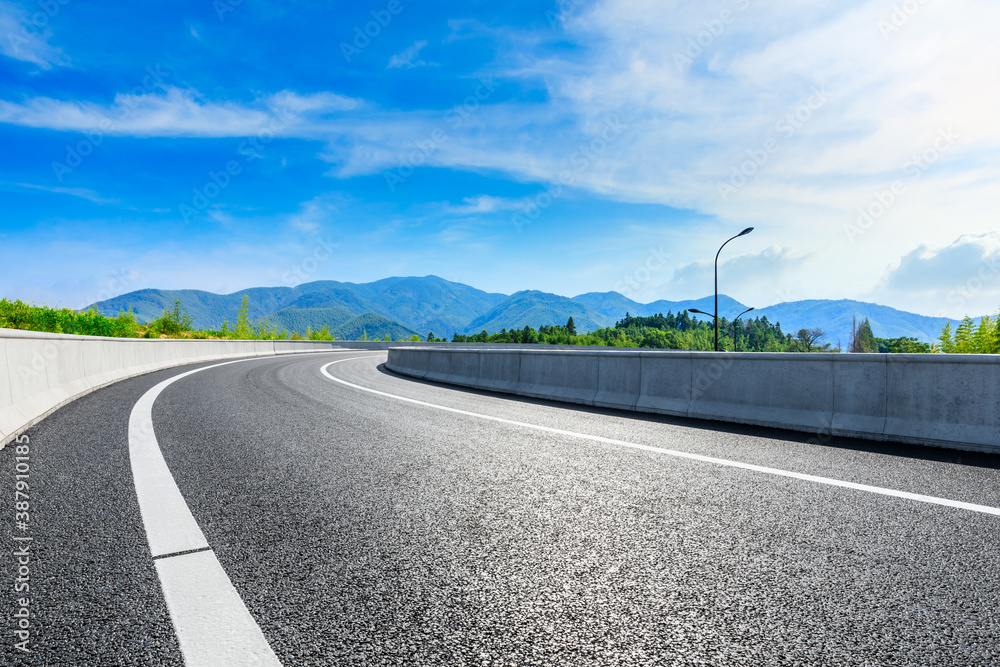 Asphalt road and green mountain natural scenery in Hangzhou on a sunny day.