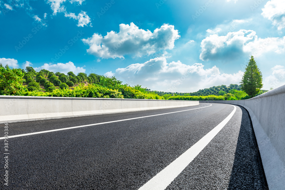 Countryside asphalt road and green tea plantations with mountain natural scenery in Hangzhou on a su