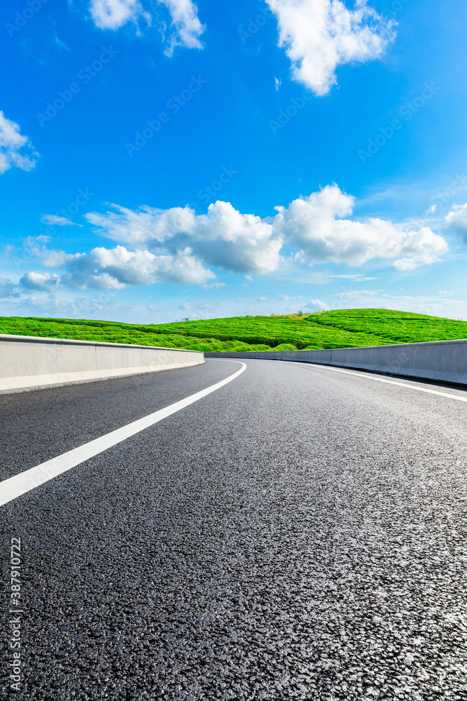 Countryside asphalt road and green tea plantations with mountain natural scenery in Hangzhou on a su