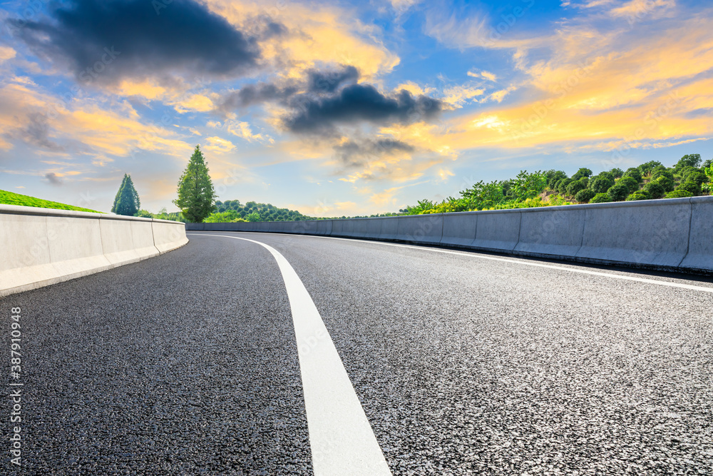 Countryside asphalt road and green tea plantations with mountain natural scenery in Hangzhou at sunr