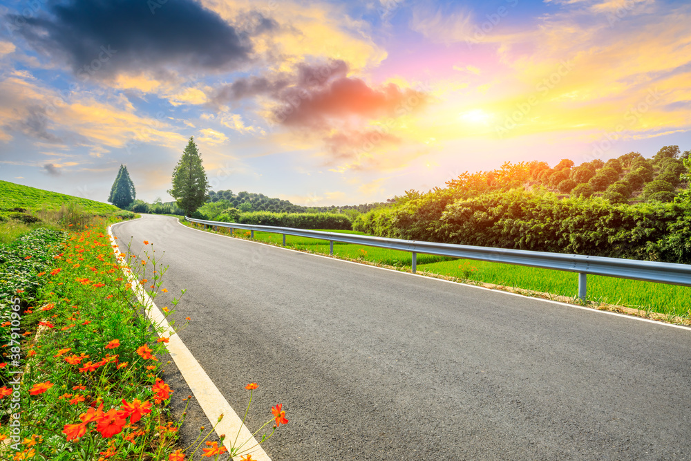 Countryside asphalt road and green tea plantations with mountain natural scenery in Hangzhou at sunr