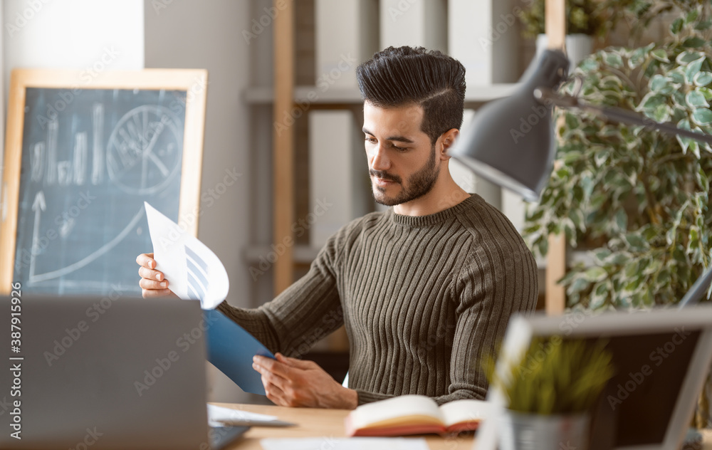 man working on a laptop at home