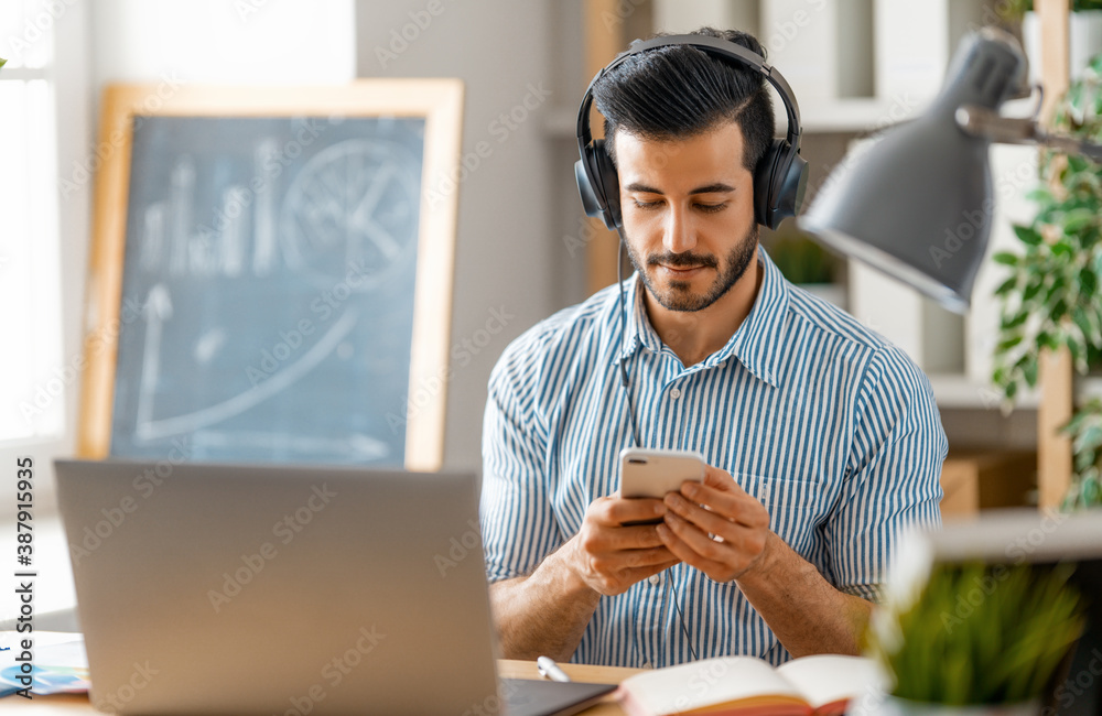 man working on a laptop at home