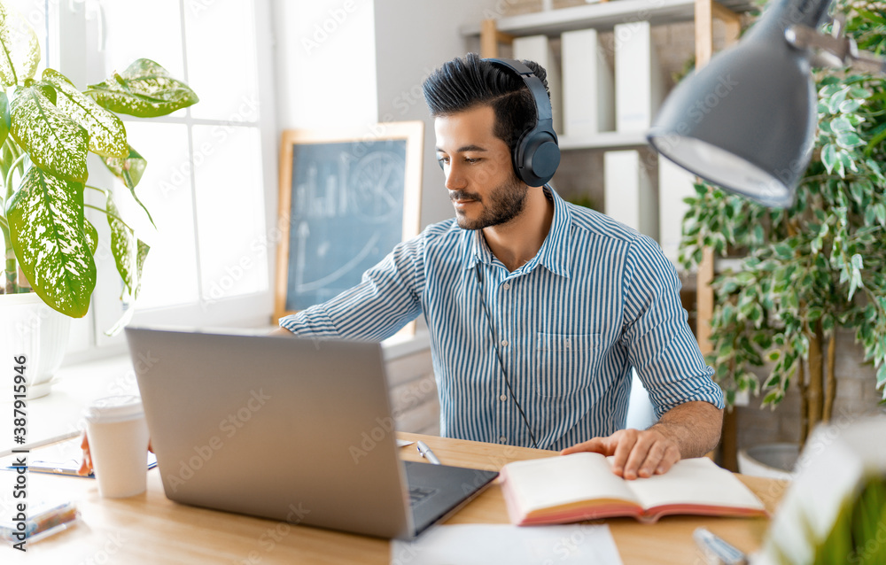 man working on a laptop at home