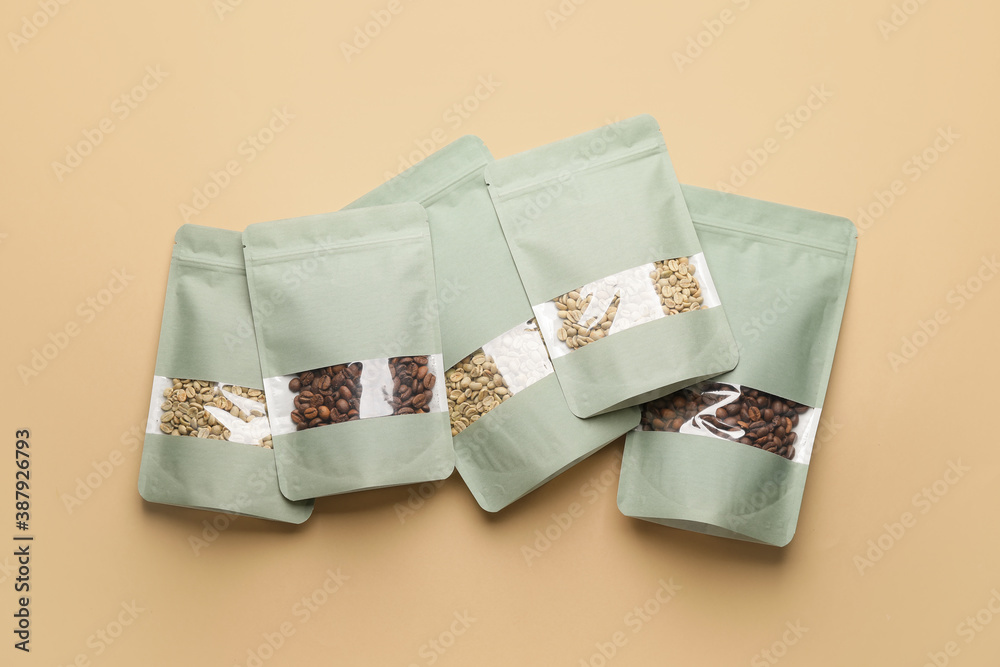 Blank coffee bags on color background