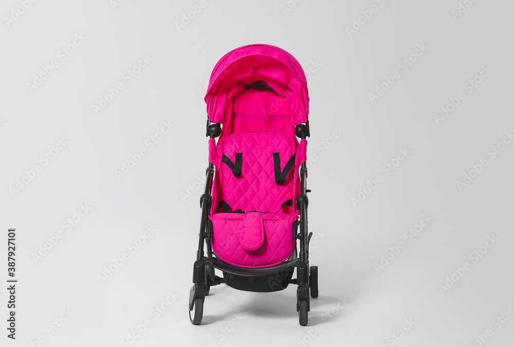 Modern baby stroller on light background