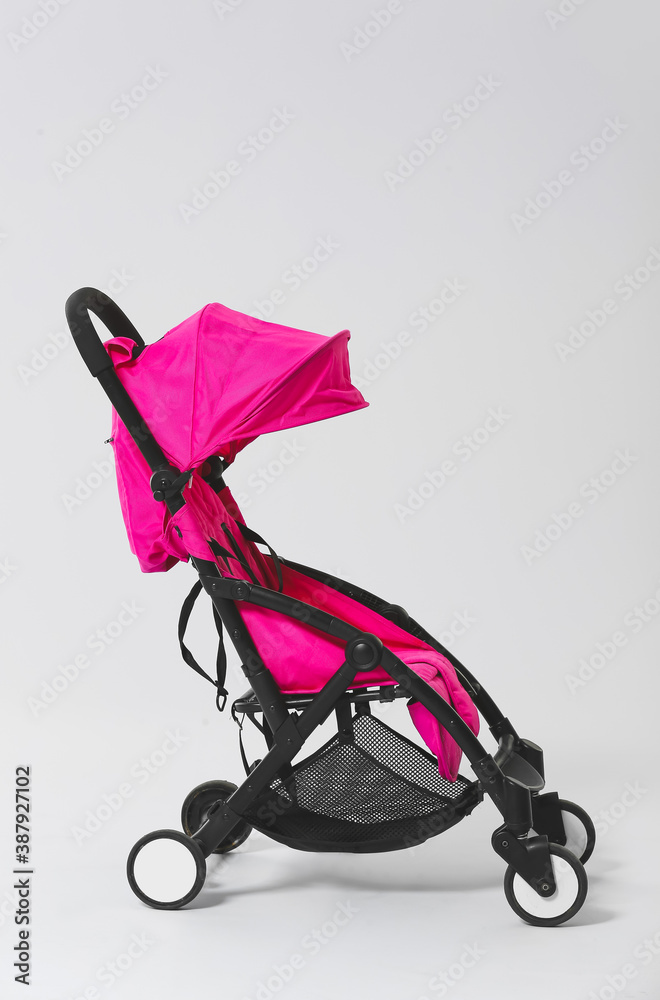 Modern baby stroller on light background