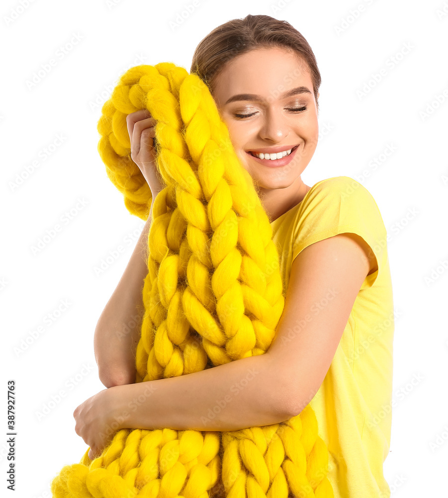 Happy young woman with warm plaid on white background