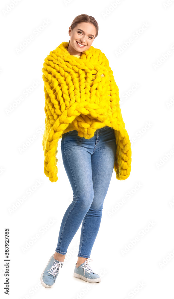 Happy young woman with warm plaid on white background