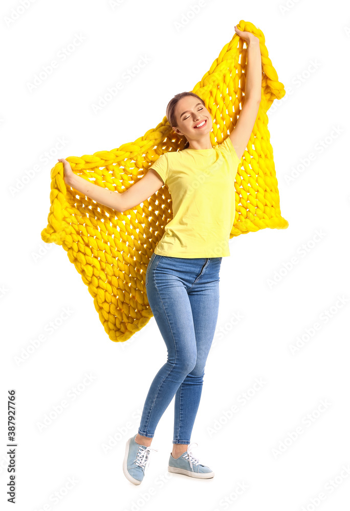 Happy young woman with warm plaid on white background