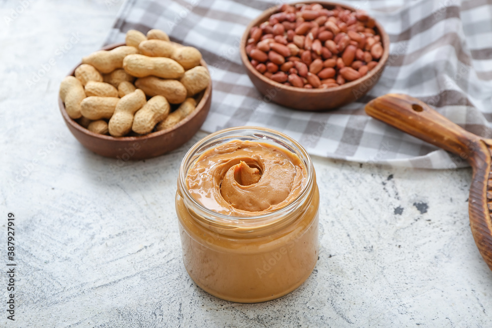 Composition with tasty peanut butter on table