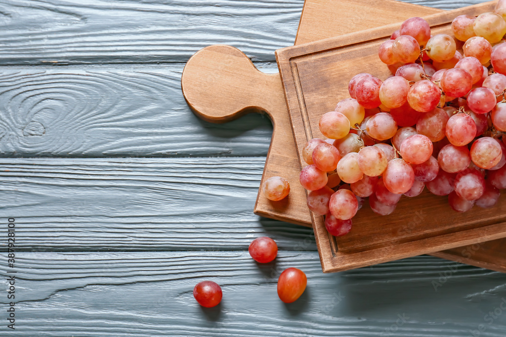 Sweet ripe grapes on wooden table