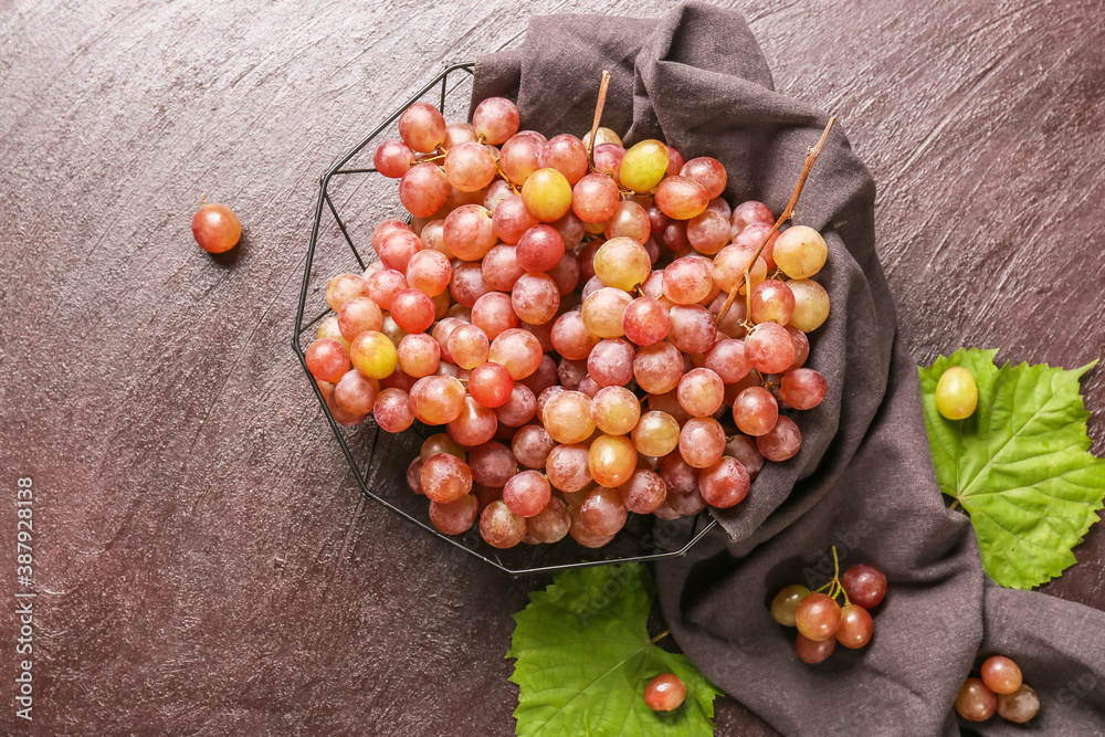 Sweet ripe grapes in bowl on table