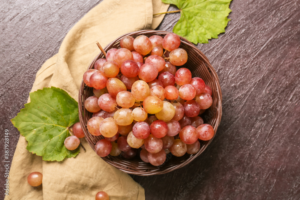 Sweet ripe grapes in bowl on table