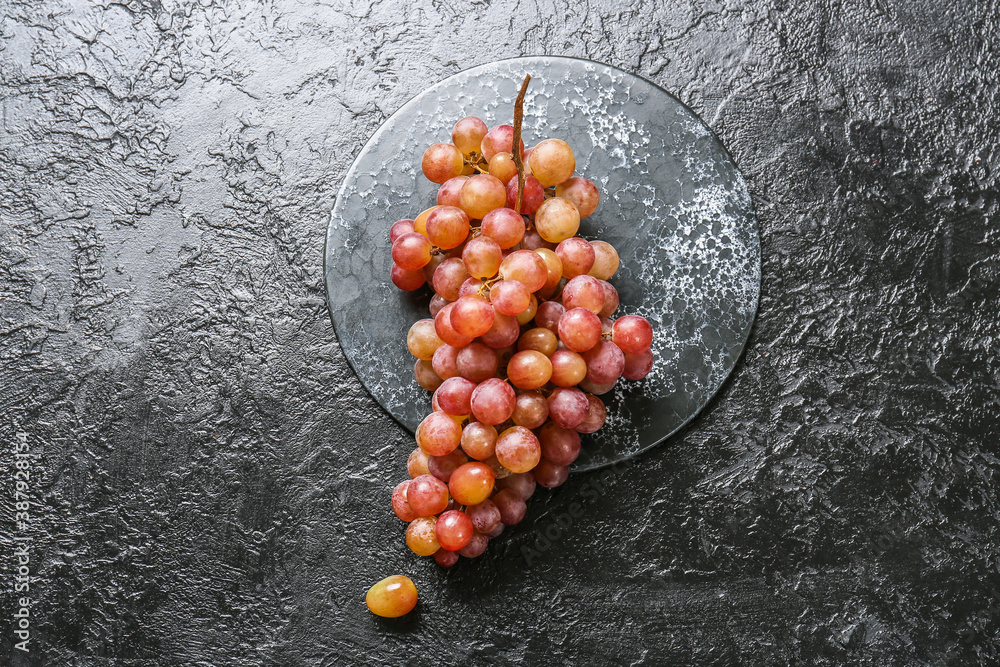 Sweet ripe grapes on dark background