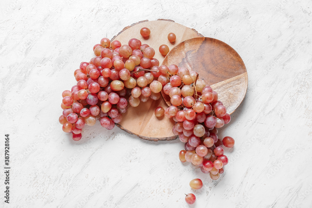 Sweet ripe grapes on light background