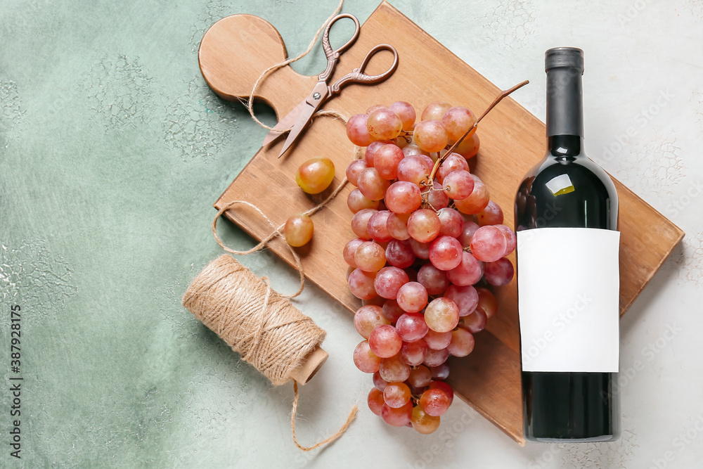 Composition with wine and sweet ripe grapes on color background