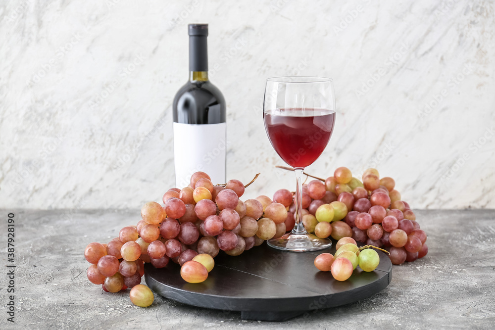 Composition with sweet ripe grapes and wine on table