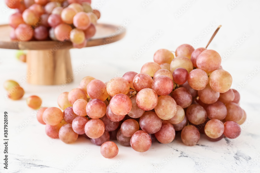 Sweet ripe grapes on light background