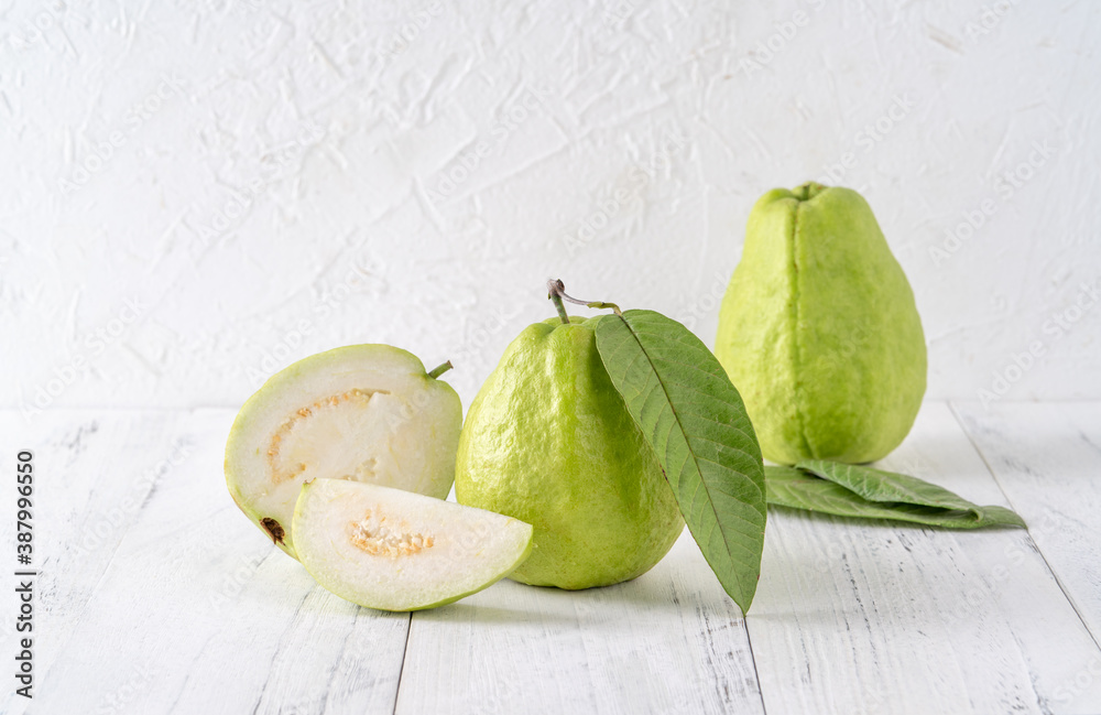 Delicious guava fruit set on white wooden table background with copy space.