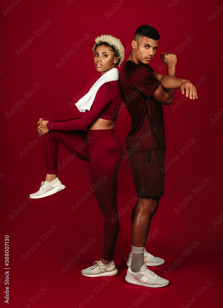 Portrait of fitness couple doing warm up exercises