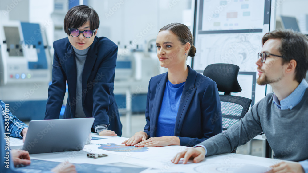 Modern Factory Office Meeting Room: Young Female Specialist Reports to Diverse Team of Engineers, Ma