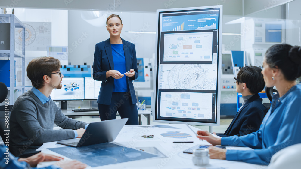 Modern Industrial Factory Meeting: Confident Female Engineer Uses Interactive Whiteboard, Makes Repo