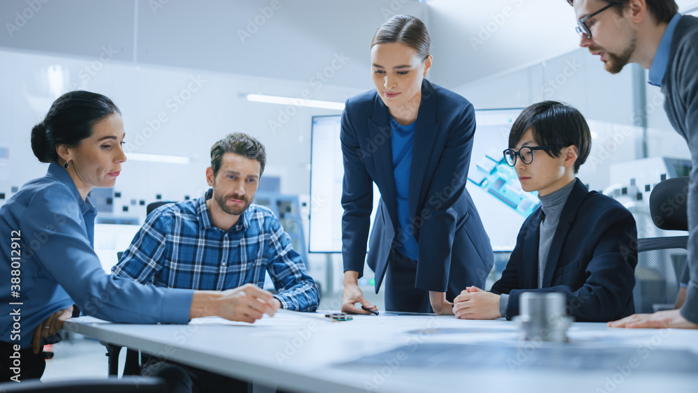 Busy Diverse Team of Computer Engineers and Specialists Gather Around Conference Table, They Discuss