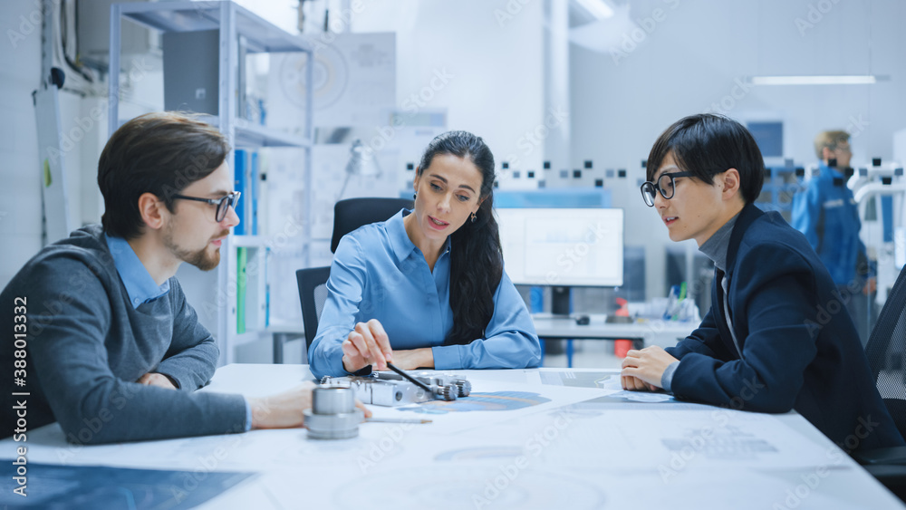 Diverse Team of Computer Engineers and Specialists Gather Around Conference Table, They Discuss Proj