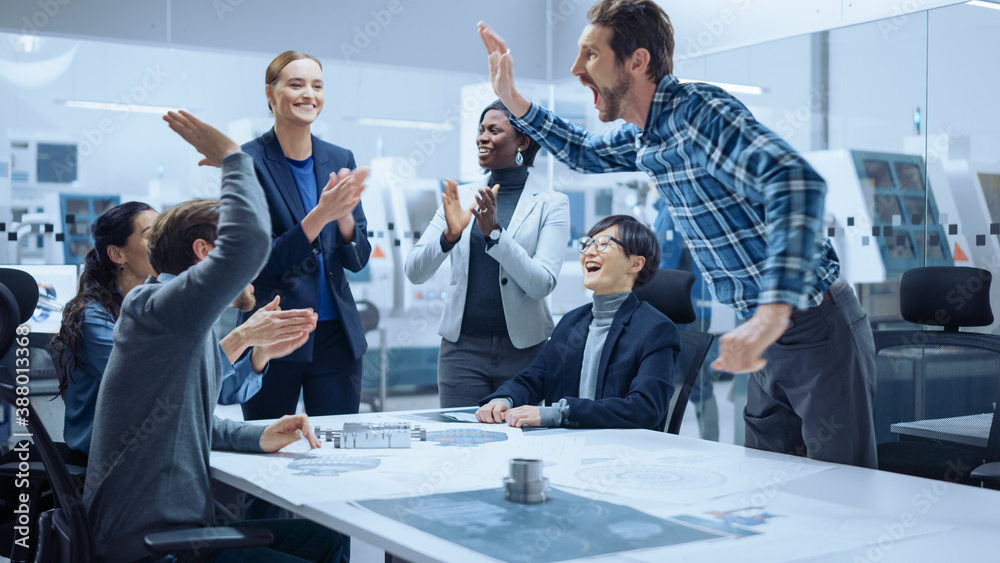 Multi Ethnic Team of Industrial Engineers Standing at the Conference Table Successfully Solve Projec