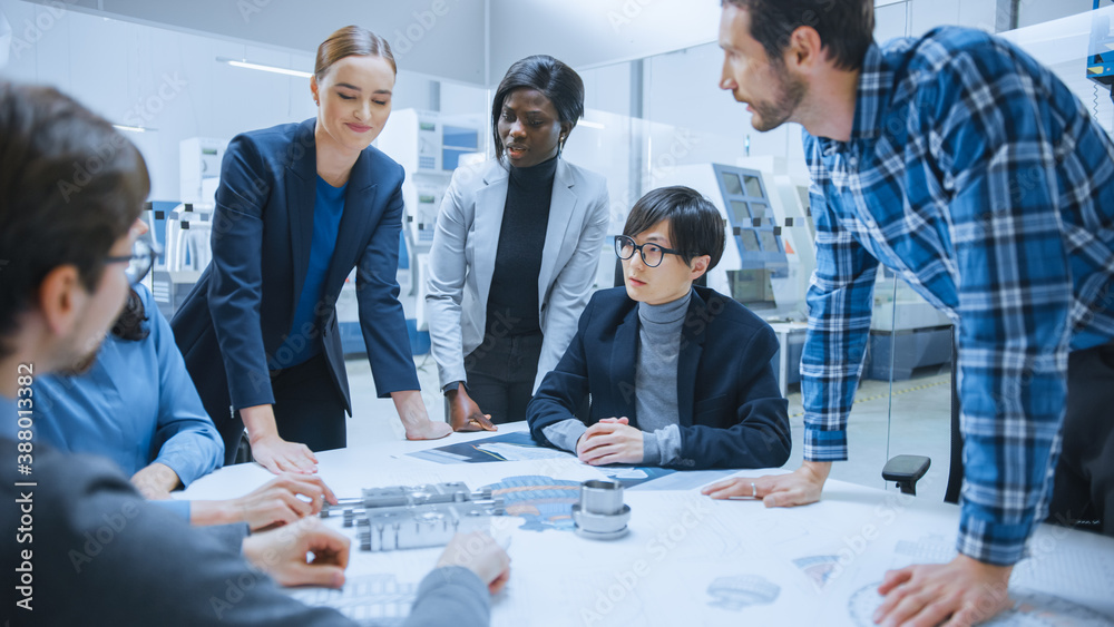 Busy Diverse Team of Engineers and Specialists Gather Around Conference Table, They Discuss Project 