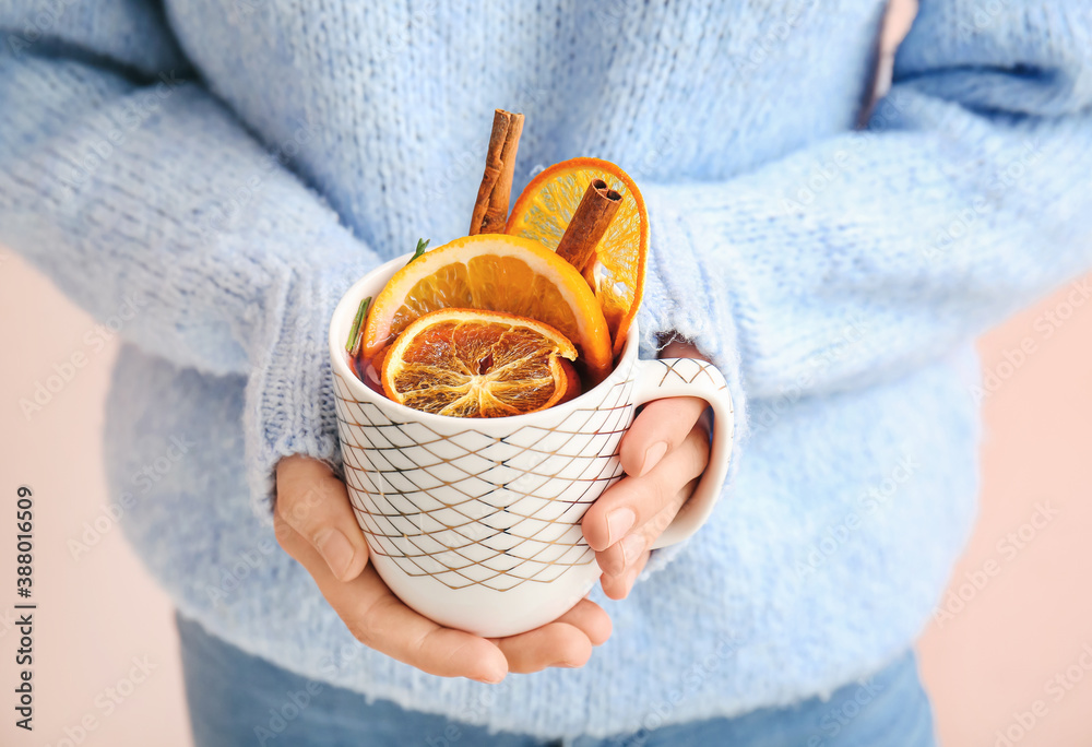 Woman with tasty mulled wine, closeup