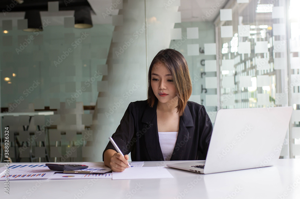 Young Asian women spend their free time using their laptop to educate themselves online and take not