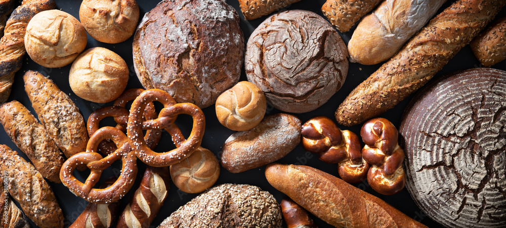 Delicious freshly baked bread assortment on dark rustic background