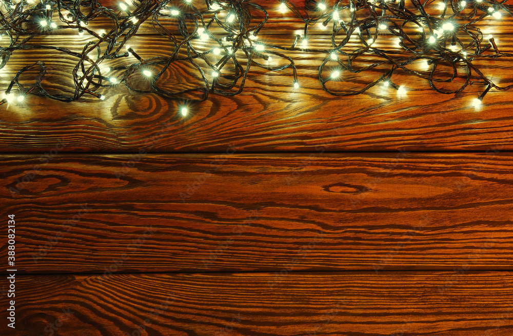 Сhristmas lights, background  ornaments on wood