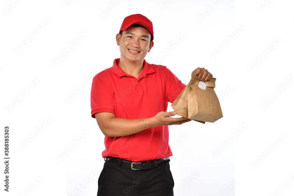 Asian delivery man in red uniform carry bags of food and drink in hands isolated on white background