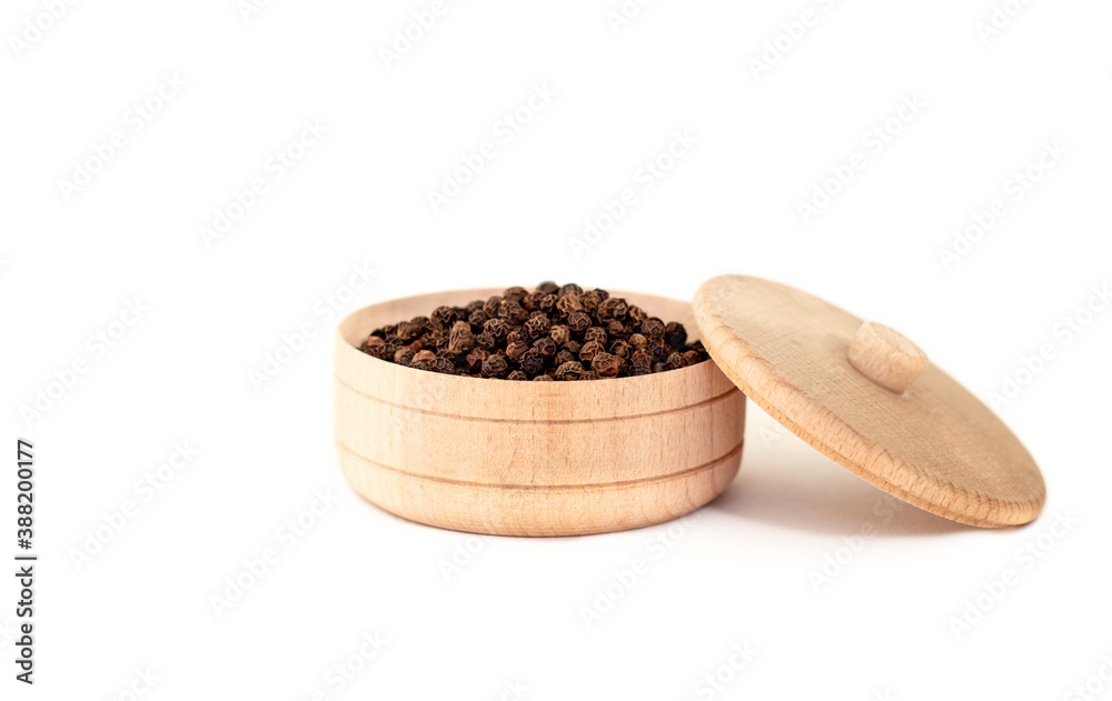 a dried aromatic black pepper in wooden bowl isolated on white background, the concept of kitchenwar