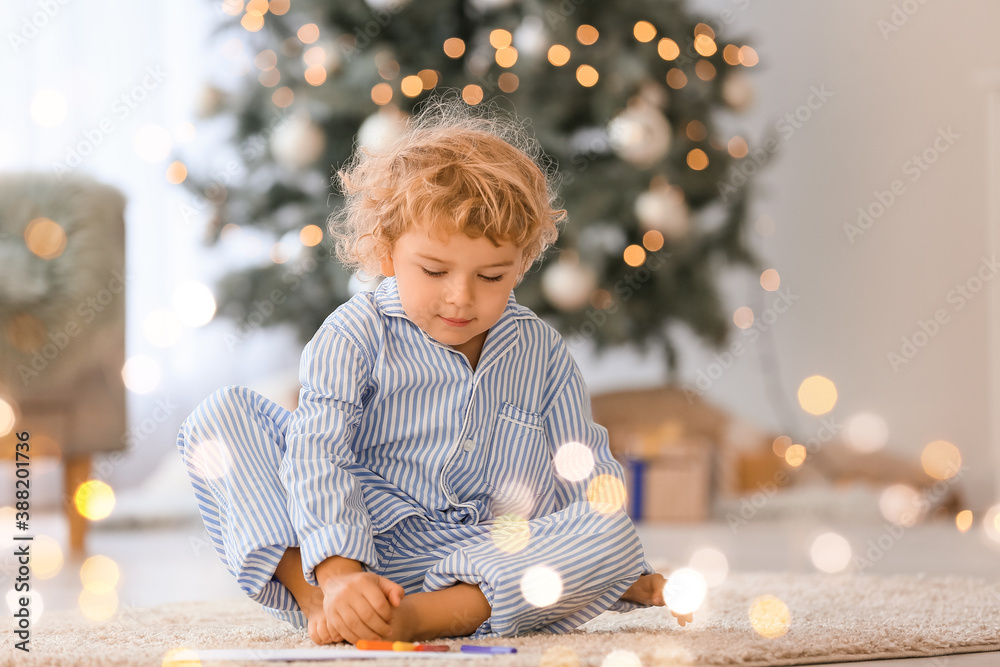 Cute little child writing letter to Santa at home