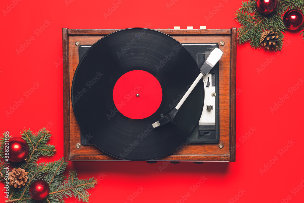 Record player and Christmas decor on color background