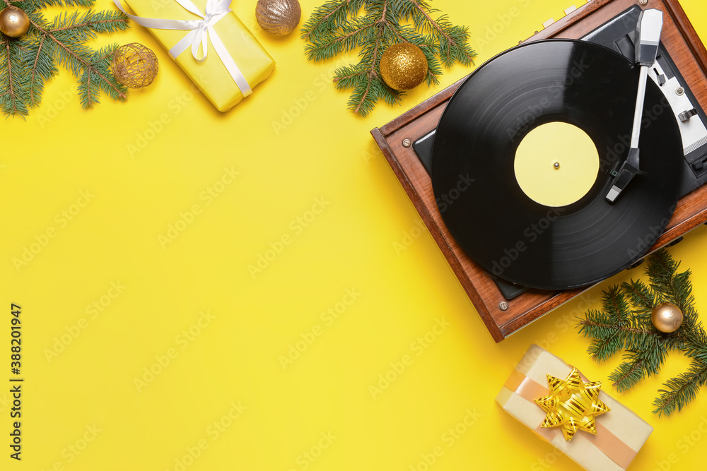 Record player and Christmas decor on color background