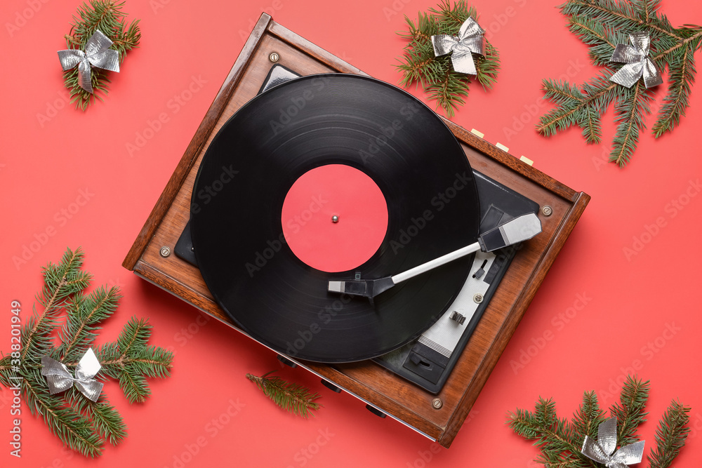 Record player and Christmas decor on color background