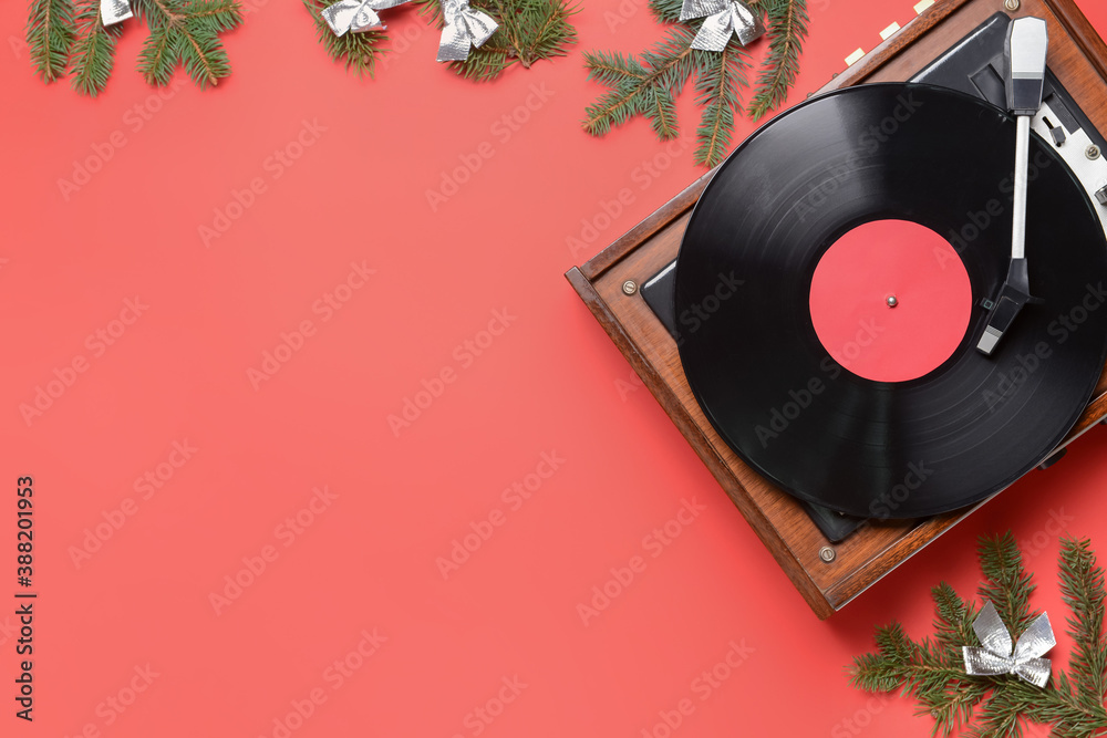 Record player and Christmas decor on color background