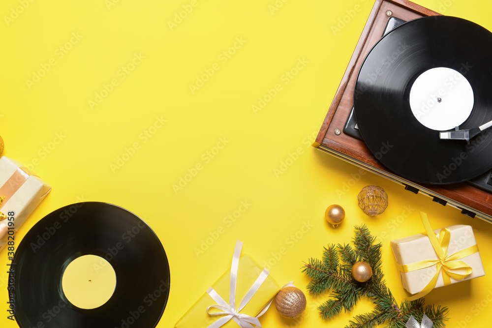 Record player and Christmas decor on color background