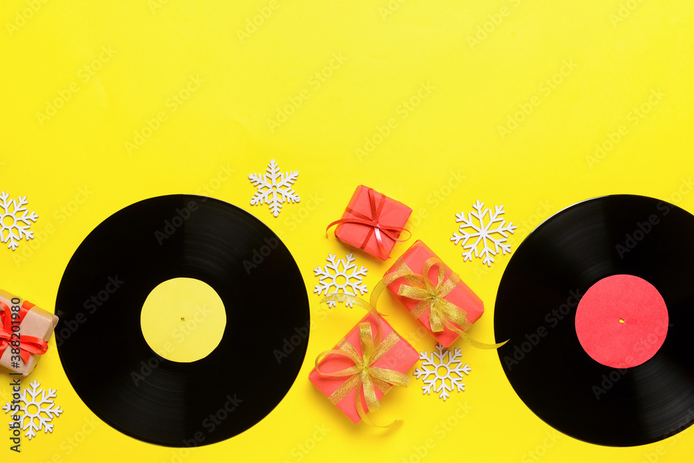 Vinyl disks and Christmas decor on color background