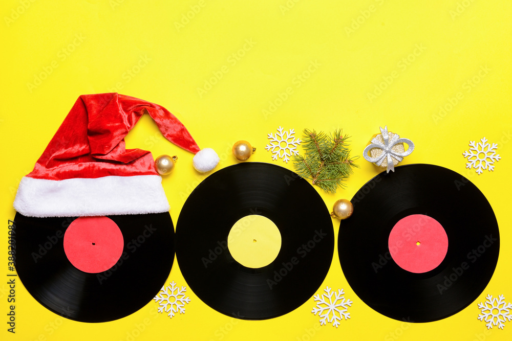 Vinyl disks and Christmas decor on color background