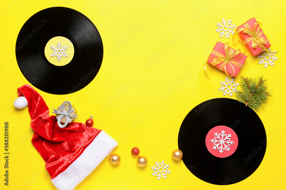 Vinyl disks and Christmas decor on color background