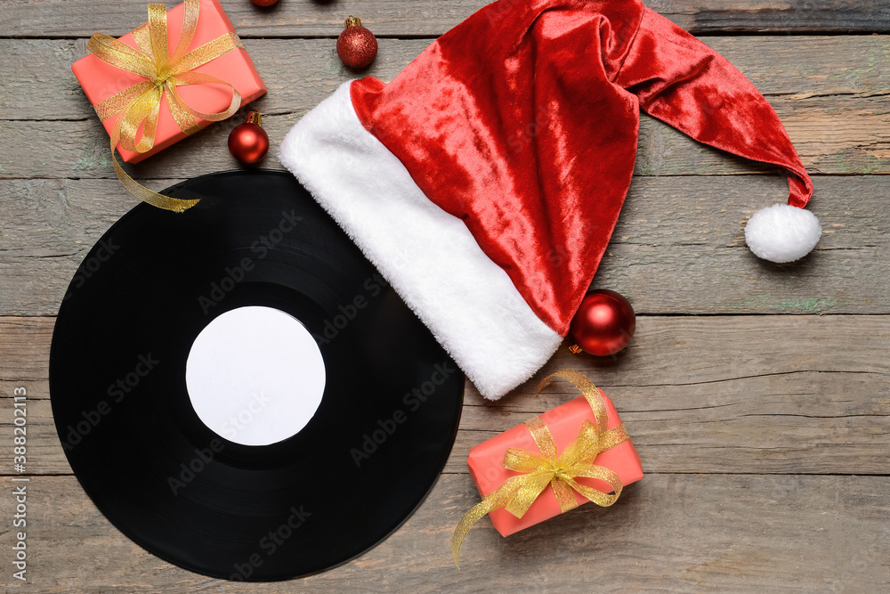 Vinyl disk and Christmas decor on wooden background