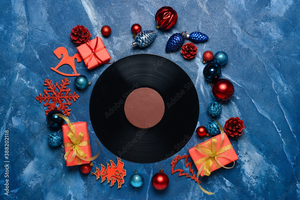 Vinyl disk and Christmas decor on color background