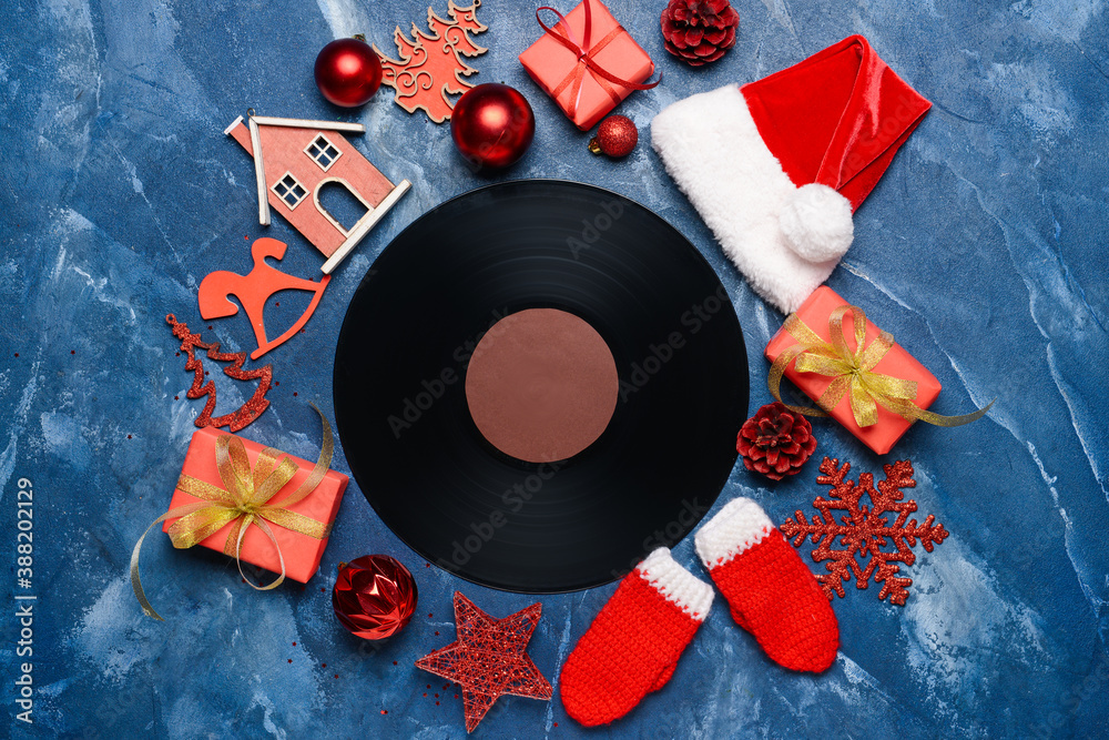 Vinyl disk and Christmas decor on color background