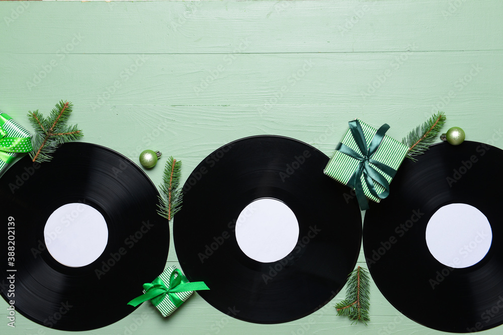 Vinyl disks and Christmas decor on color background